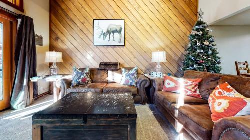 a living room with a couch and a christmas tree at Snowcreek Iii #415 Condo in Mammoth Lakes