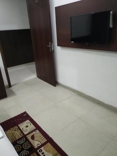 a room with a flat screen tv on a wall at Hotel Popular in Amritsar