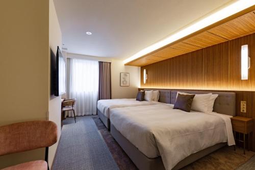Säng eller sängar i ett rum på The OneFive Terrace Fukuoka