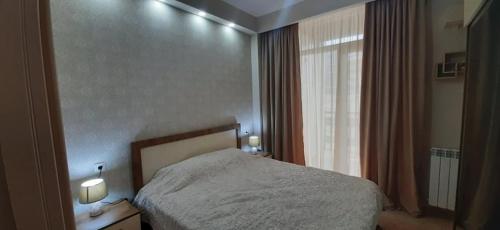 1 dormitorio con cama y ventana en The Apartment for Comfortable Vacations in Tbilisi., en Tiflis