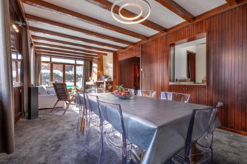 a dining room with a long table and chairs at Chalet Clos 66 in Chamonix