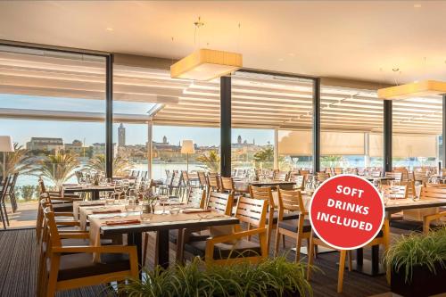 a restaurant with tables and chairs and a sign that says soft drinks involved at Valamar Padova Hotel in Rab