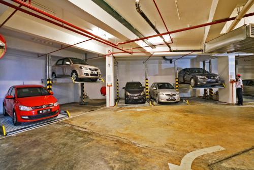a parking garage with three cars parked in it at Cititel Express Ipoh in Ipoh