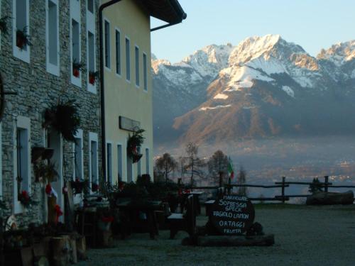 a building with a view of a snow covered mountain at Agriturismo La Casa Nei Boschi in Colderù