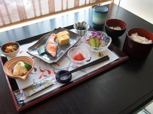 a tray of food on a table with sushi at Tabist Hotel Tetora Kitakyushu in Kitakyushu