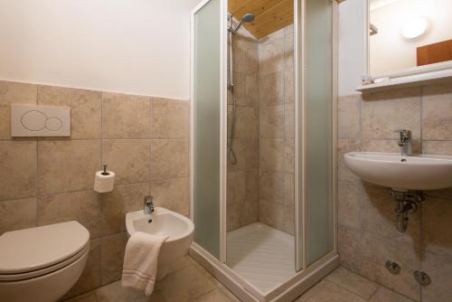 a bathroom with a shower and a toilet and a sink at Hotel Consul Dipendenza "la Plata" con piscina in Riccione