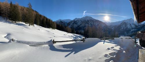 a shadow of a person on a snow covered mountain at Ferienhof Oberer Gollmitzer in Heiligenblut
