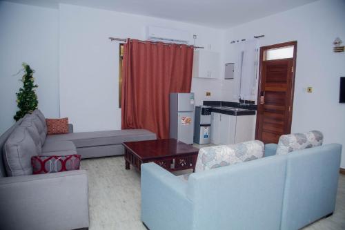 a living room with two couches and a table at Sheratton Beach Villagio in Mombasa