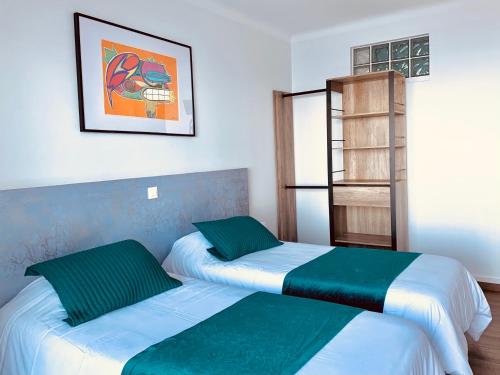 a bedroom with two beds and a book shelf at Il Tramonto in Calvi