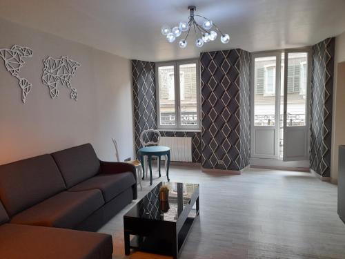 a living room with a couch and a table at Colmar Historic Center - LES CLEFS DE COLMAR - BookingAlsace in Colmar