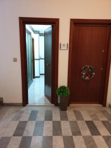 a hallway with a door and a potted plant at Alba central City in Palermo