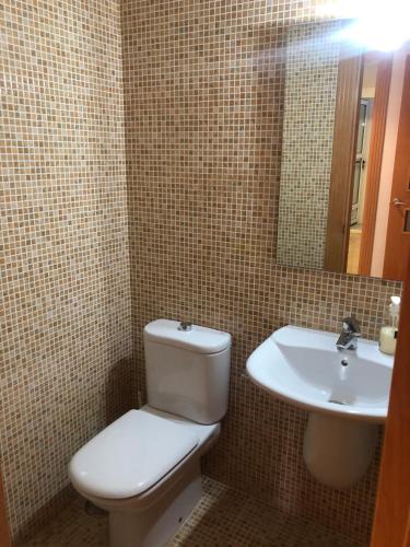 a bathroom with a toilet and a sink at Las salinas Roquetas de Mar in Roquetas de Mar