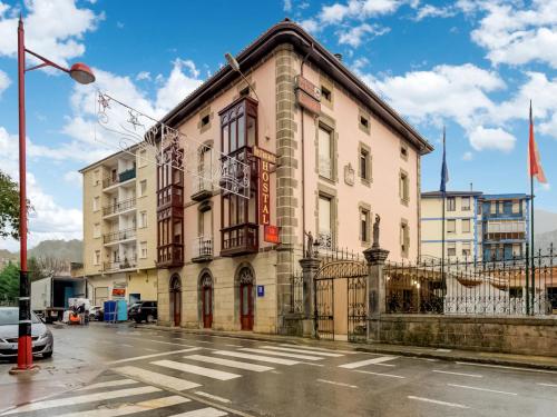 a building on the corner of a street at Hostal Restaurante La pinta in Ampuero