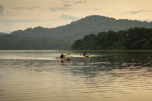 two people in kayaks on a body of water at Mapakada Village - Mahiyanganaya in Mahiyangana