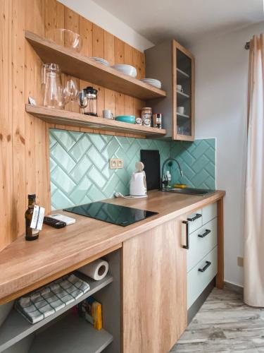 a kitchen with wooden cabinets and a counter top at Penzion U Kapličky in Znojmo