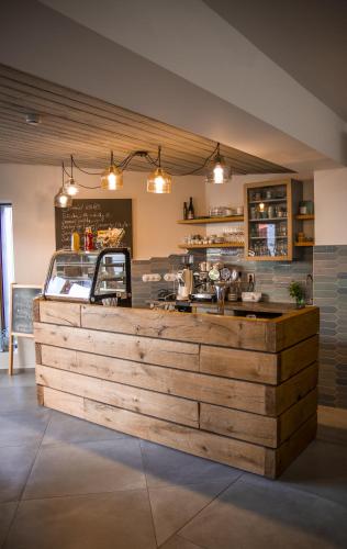 a restaurant with a wooden counter in a room at Penzion U Kapličky in Znojmo