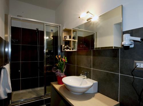 a bathroom with a sink and a shower at Tus'Hotel in Castel di Tusa