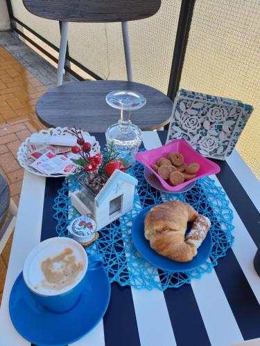 a table with a tray of pastries and a cup of coffee at Alba central City in Palermo