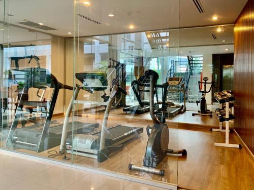 un gimnasio con cintas de correr y elípticas en una habitación en The Bedrooms Boutique Hotel Bangkok, en Bangkok