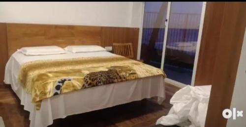 a bedroom with a bed with a leopard blanket at QUILON BEACH Inn in Kollam