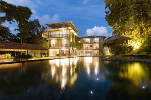 a house with a swimming pool at night at Mapakada Village - Mahiyanganaya in Mahiyangana