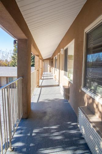 an empty hallway of a building with a sidewalk at Sterling Inn in Santa Clara