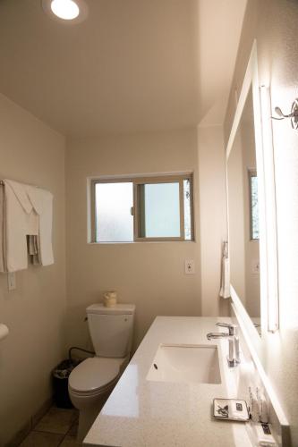 a bathroom with a toilet and a sink at Sterling Inn in Santa Clara