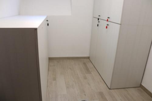 an empty room with white walls and a wooden floor at Sun Bologna in Bologna