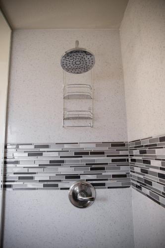 a shower with a towel rack in a bathroom at Sterling Inn in Santa Clara