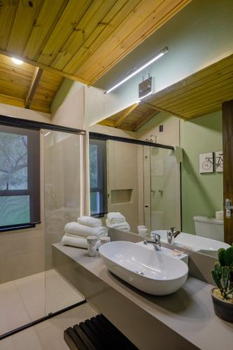 a bathroom with a white sink and a shower at Pousada Natural Park in Imbituba