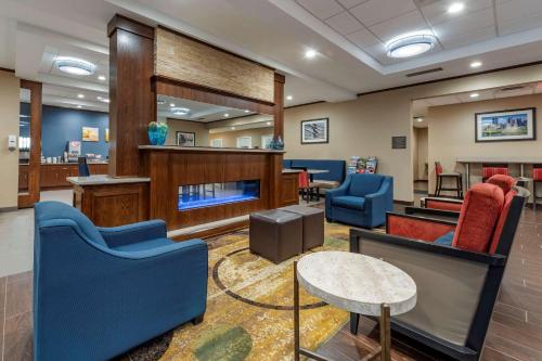 a waiting room at a hospital with blue chairs and a table at Comfort Inn & Suites Pittsburgh South in Pittsburgh