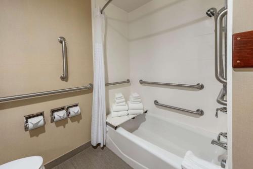 a bathroom with a bath tub and a toilet at Comfort Inn & Suites in Pittsburgh