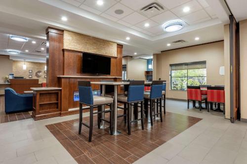 a conference room with a table and chairs and a television at Comfort Inn & Suites Pittsburgh South in Pittsburgh