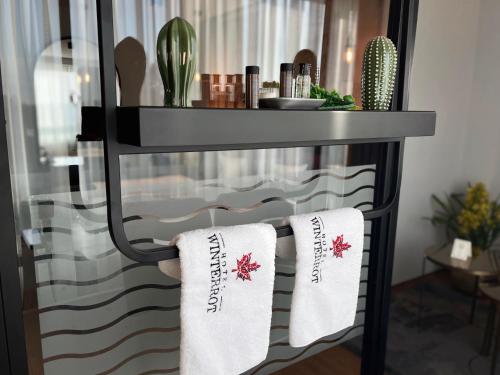 a shelf with two white pillows on it at Design Hotel Winterrot in Karlsruhe