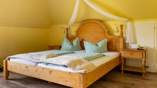 a bedroom with a wooden bed with a canopy at Hotel Villa Tummelchen in Cochem