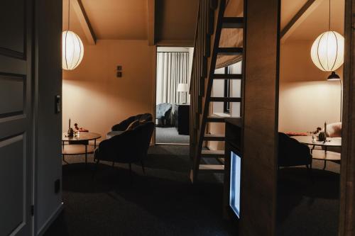 a room with a staircase and two tables and chairs at Hotell Viktors in Sälen