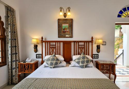 a bedroom with a bed with two pillows at Amet Haveli - A Heritage Hotel Udaipur in Udaipur