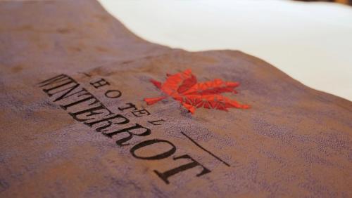 a persons back with a tattoo with a maple leaf on it at Design Hotel Winterrot in Karlsruhe