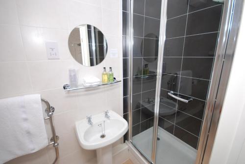 a bathroom with a shower and a sink at Westbury Lodge in Shanklin