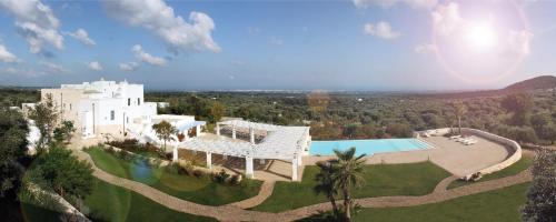 an aerial view of a house with a swimming pool at Masseria Santa Teresa in Monopoli