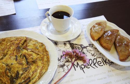 a table with a plate of food and a cup of coffee at Mpelleiko in Stemnitsa
