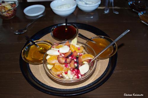 a bowl of food with fruit and a spoon at Mpelleiko in Stemnitsa