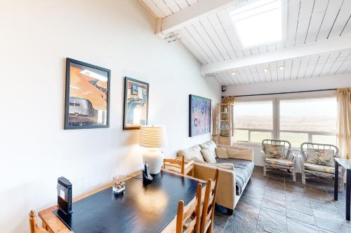 a living room with a table and a couch at Captain's Quarters in Seaside