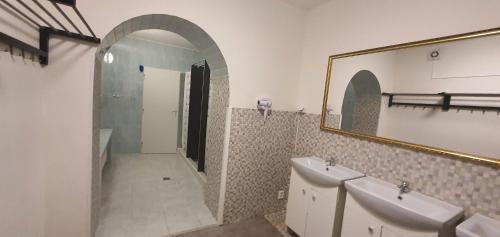 a bathroom with two sinks and a mirror at M-Tourist in Prague