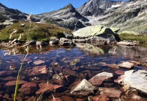 a mountain lake with rocks and mountains in the background at Landhof Aigner in Mittersill