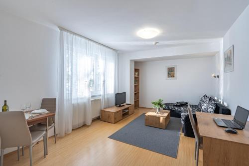 a living room with a couch and a table at Wili Tatry Apartments in Tatranská Lomnica