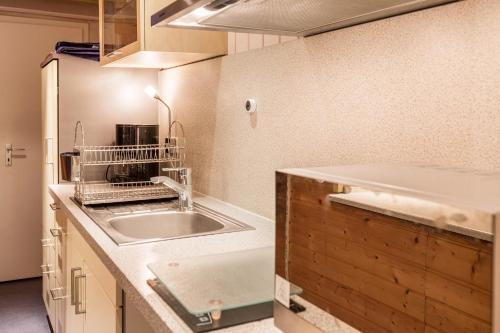 a kitchen with a sink and a microwave at Ferienwohnung Faden in Konstanz