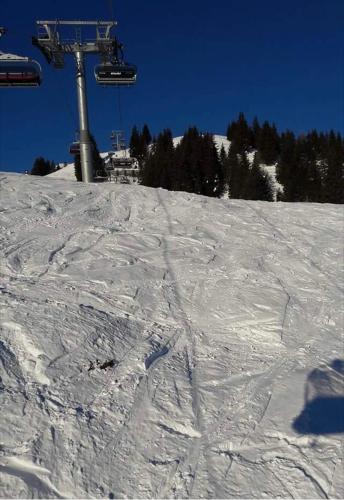 a snow covered ski slope with a ski lift at Landhof Aigner in Mittersill