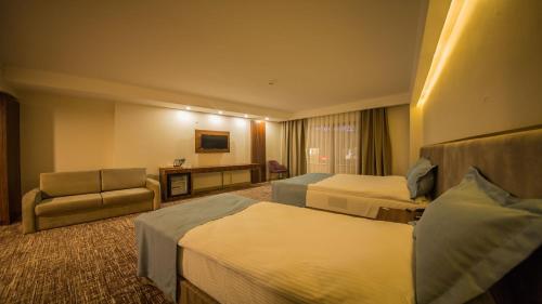 Ένα ή περισσότερα κρεβάτια σε δωμάτιο στο Bendis Hotel