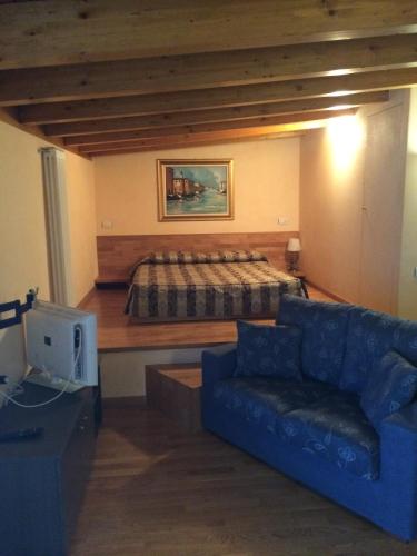 a living room with a couch and a bed at Hotel Concordia in Porlezza